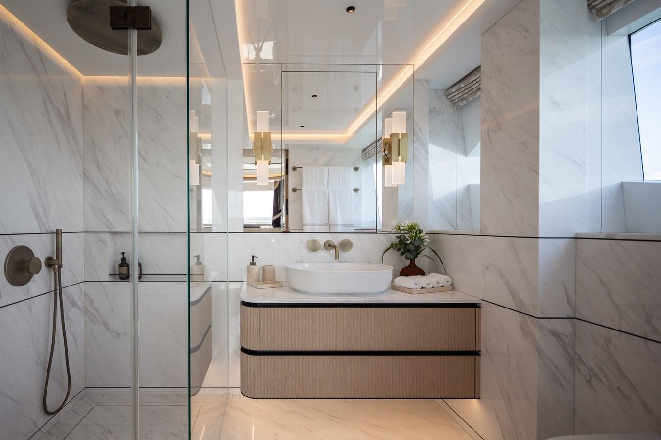 a bathroom with a sink and a mirror aboard MOONEN 110 MUSTIQUE Yacht for Sale