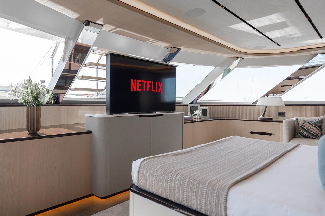 a bed and a tv in a room aboard MOONEN 110 MUSTIQUE Yacht for Sale