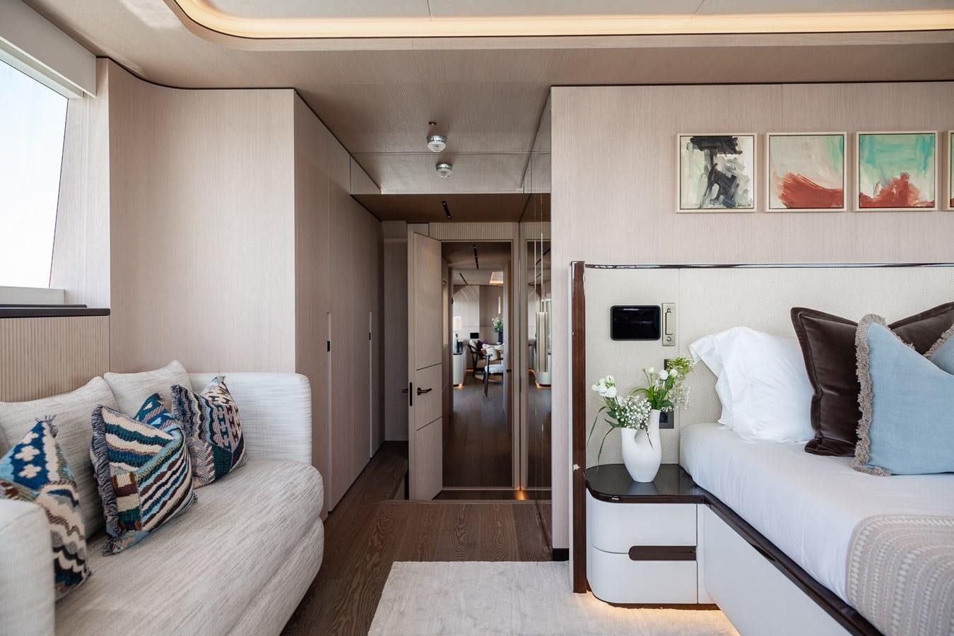 a living room with a couch and a door aboard MOONEN 110 MUSTIQUE Yacht for Sale