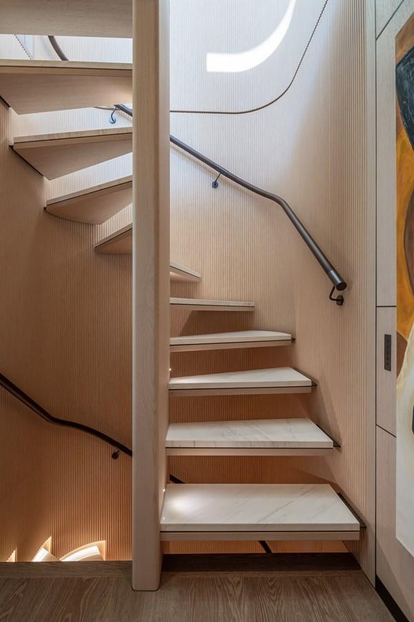 a set of wooden stairs aboard MOONEN 110 MUSTIQUE Yacht for Sale