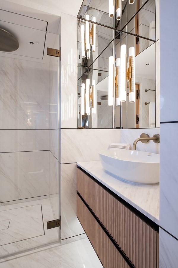 a bathroom with a sink and a mirror aboard MOONEN 110 MUSTIQUE Yacht for Sale