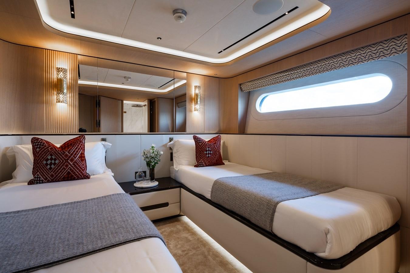 a room with two beds aboard MOONEN 110 MUSTIQUE Yacht for Sale