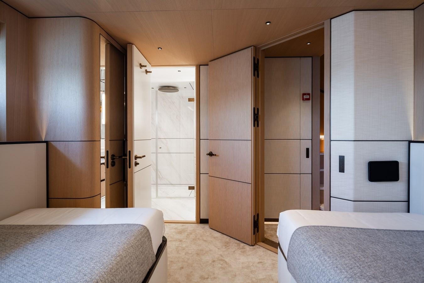 a room with a bed and a closet aboard MOONEN 110 MUSTIQUE Yacht for Sale