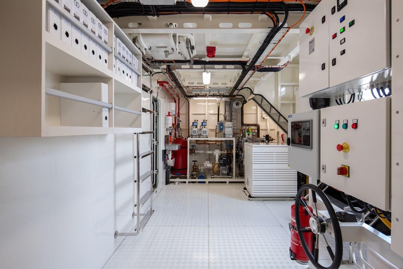 a room with white walls and white walls and a red bike aboard MOONEN 110 MUSTIQUE Yacht for Sale