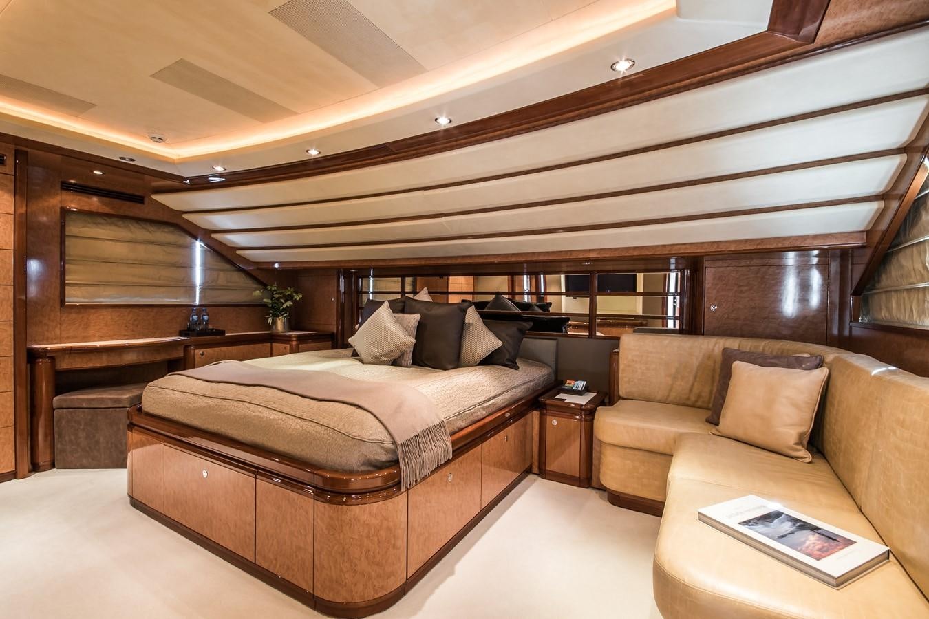 a bed and a couch in a room aboard QUEEN OF SHEBA Yacht for Sale