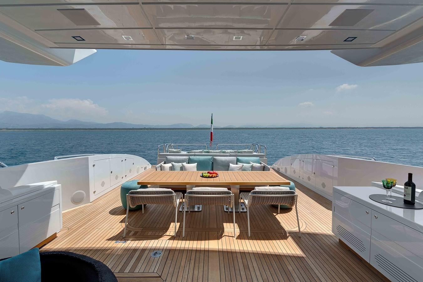 a room with a table and chairs aboard MANGUSTA 110 - CAREFULLY USED Yacht for Sale