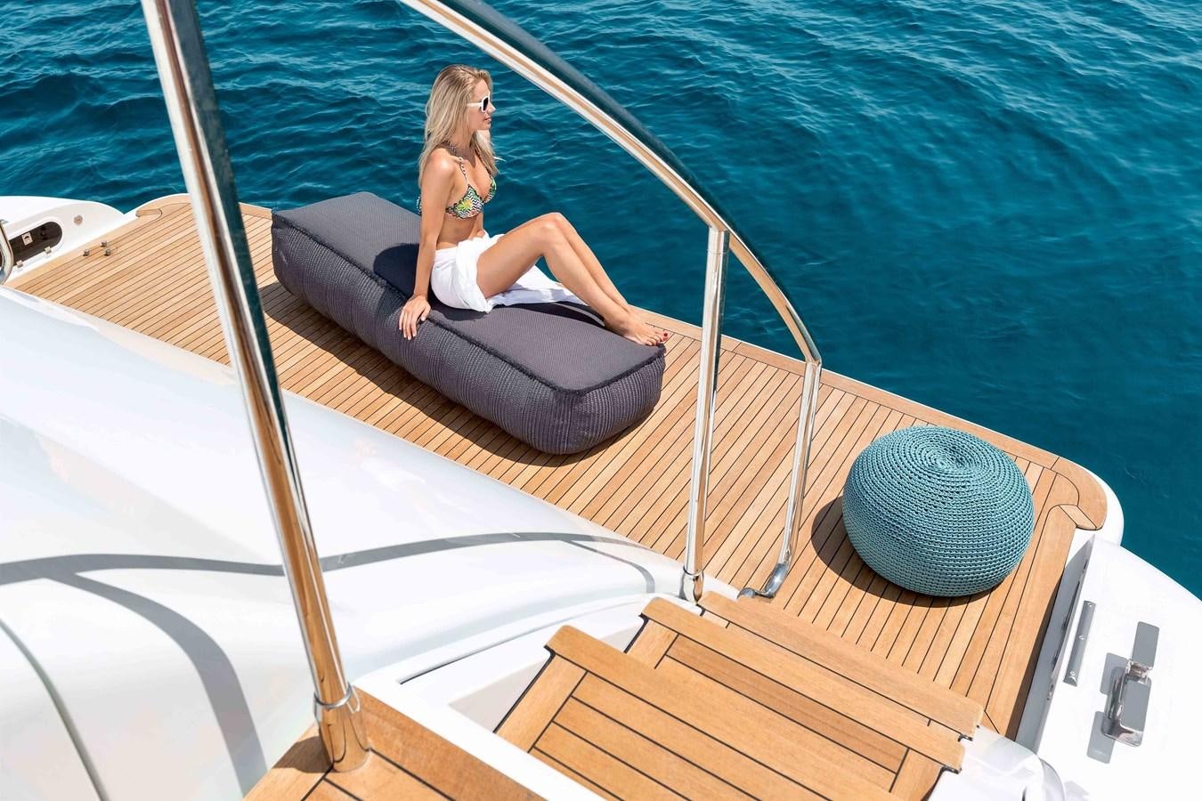 a woman sitting on a boat aboard MANGUSTA 110 - CAREFULLY USED Yacht for Sale