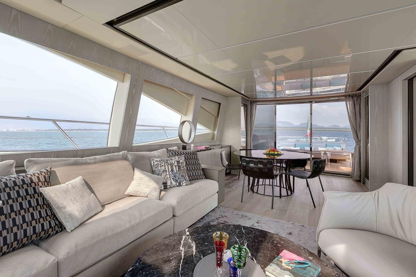 a living room with a large window aboard MANGUSTA 110 - CAREFULLY USED Yacht for Sale