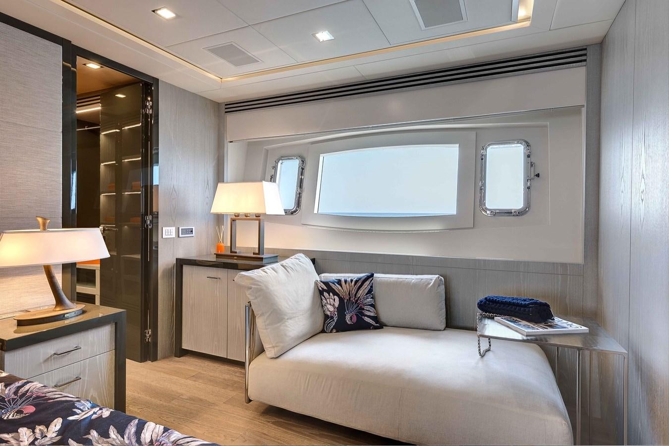 a living room with a bed and a desk aboard MANGUSTA 110 - CAREFULLY USED Yacht for Sale