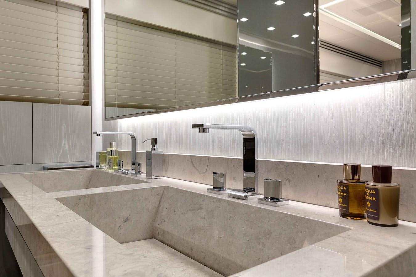 a bathroom with a countertop sink and a large mirror aboard MANGUSTA 110 - CAREFULLY USED Yacht for Sale