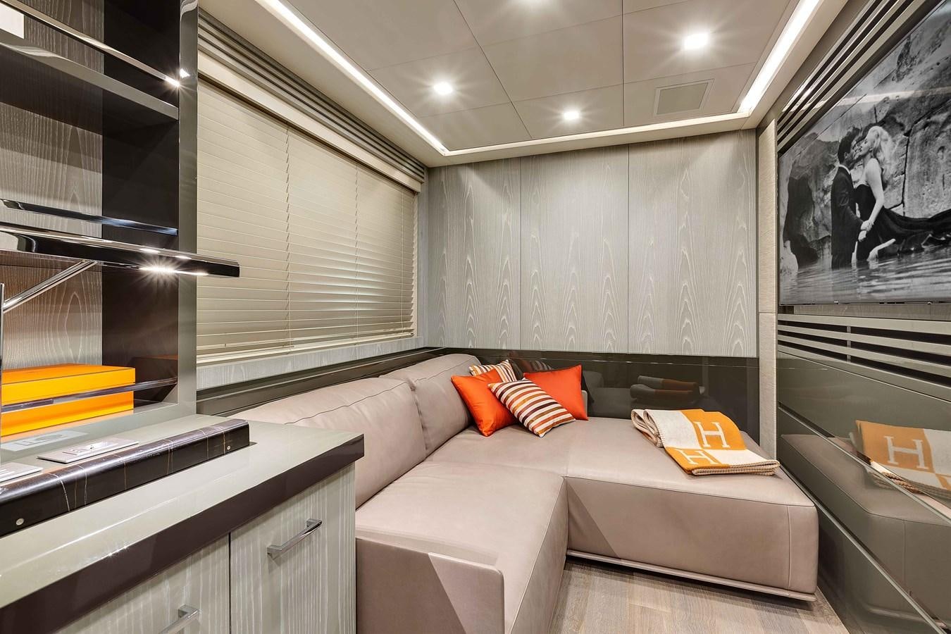 a room with a couch and a mirror aboard MANGUSTA 110 - CAREFULLY USED Yacht for Sale