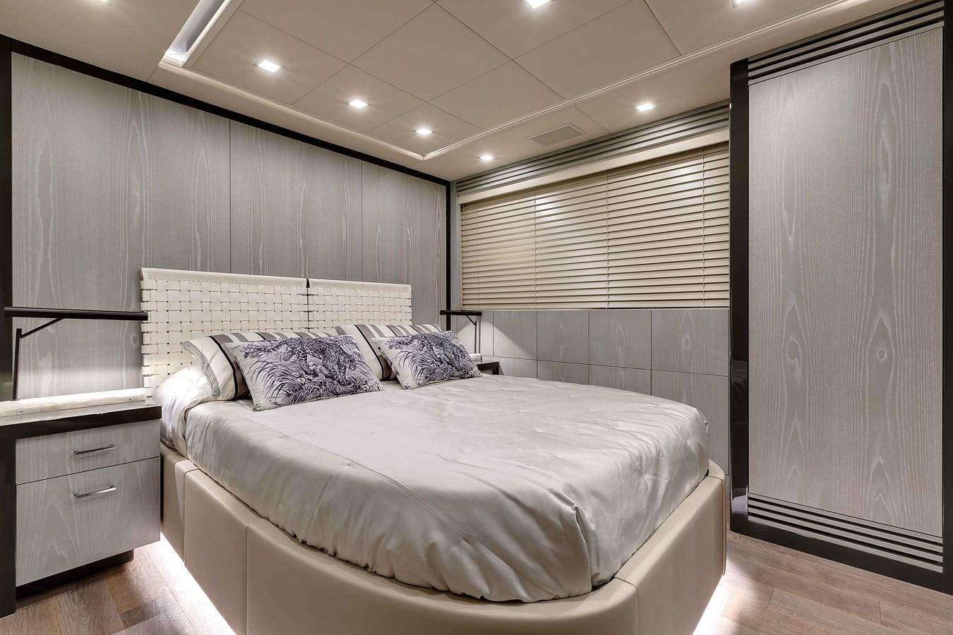 a bedroom with a bed and a desk aboard MANGUSTA 110 - CAREFULLY USED Yacht for Sale