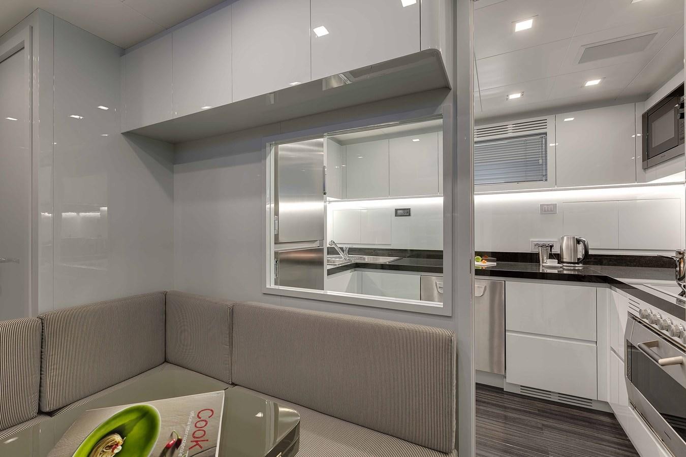 a kitchen with a glass door aboard MANGUSTA 110 - CAREFULLY USED Yacht for Sale