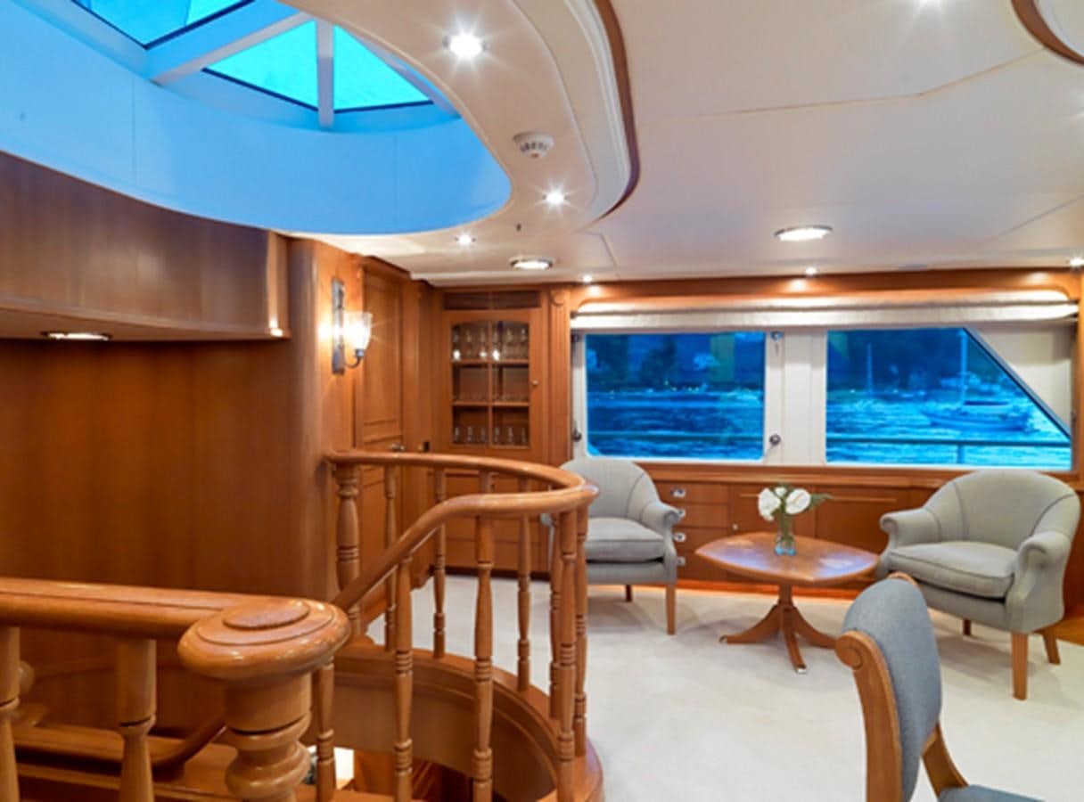 a room with a table chairs and a window aboard DONA AMELIA II Yacht for Sale