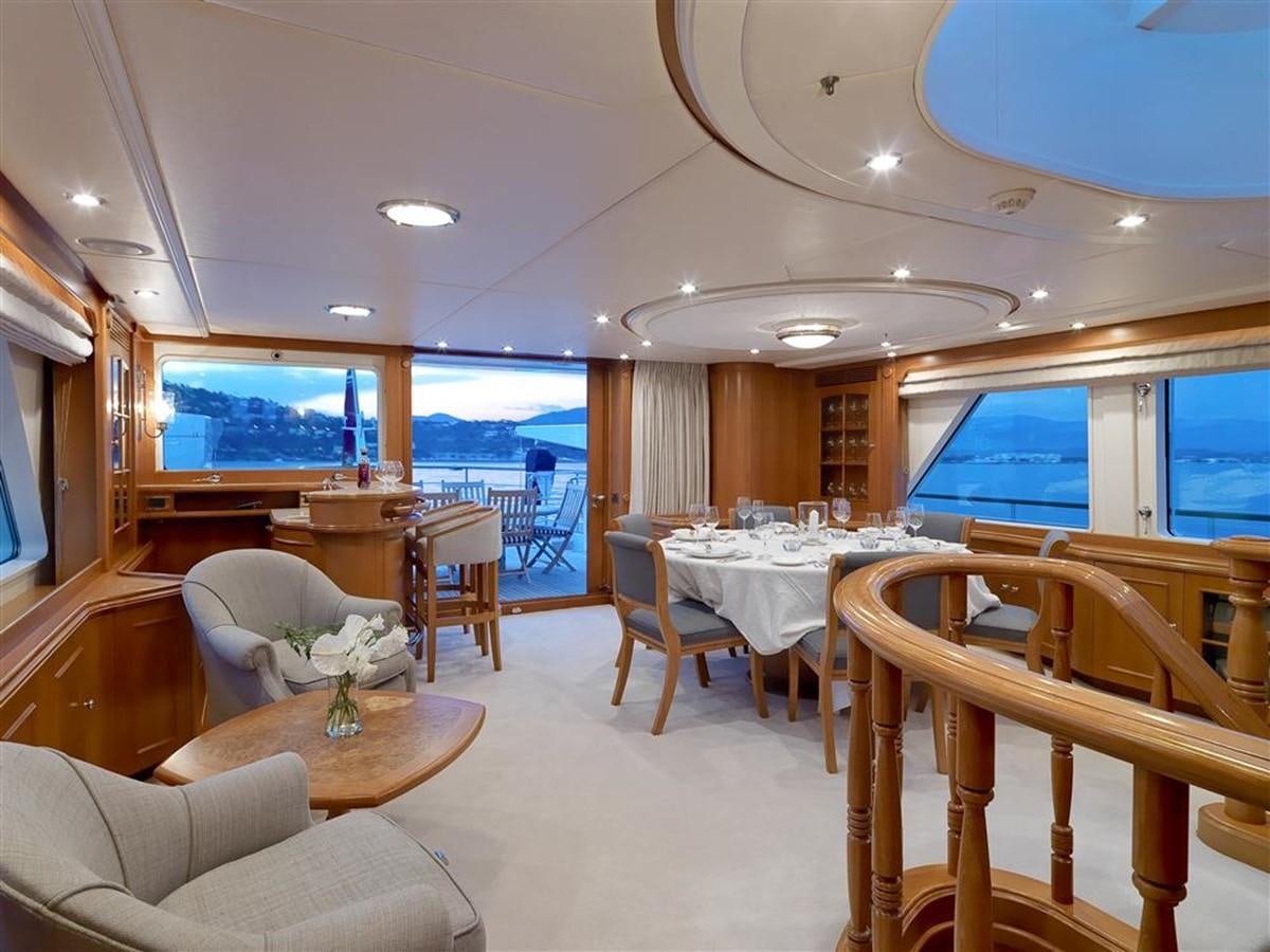 a large dining room with a large window overlooking a large ocean aboard DONA AMELIA II Yacht for Sale
