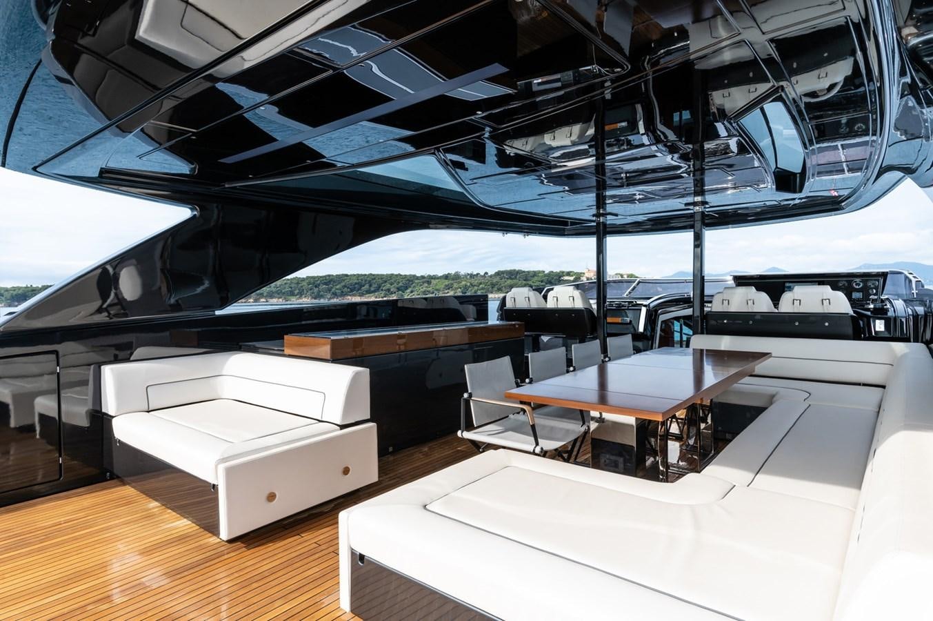 a room with tables and chairs aboard RIVA DOLCEVITA 110 Yacht for Sale