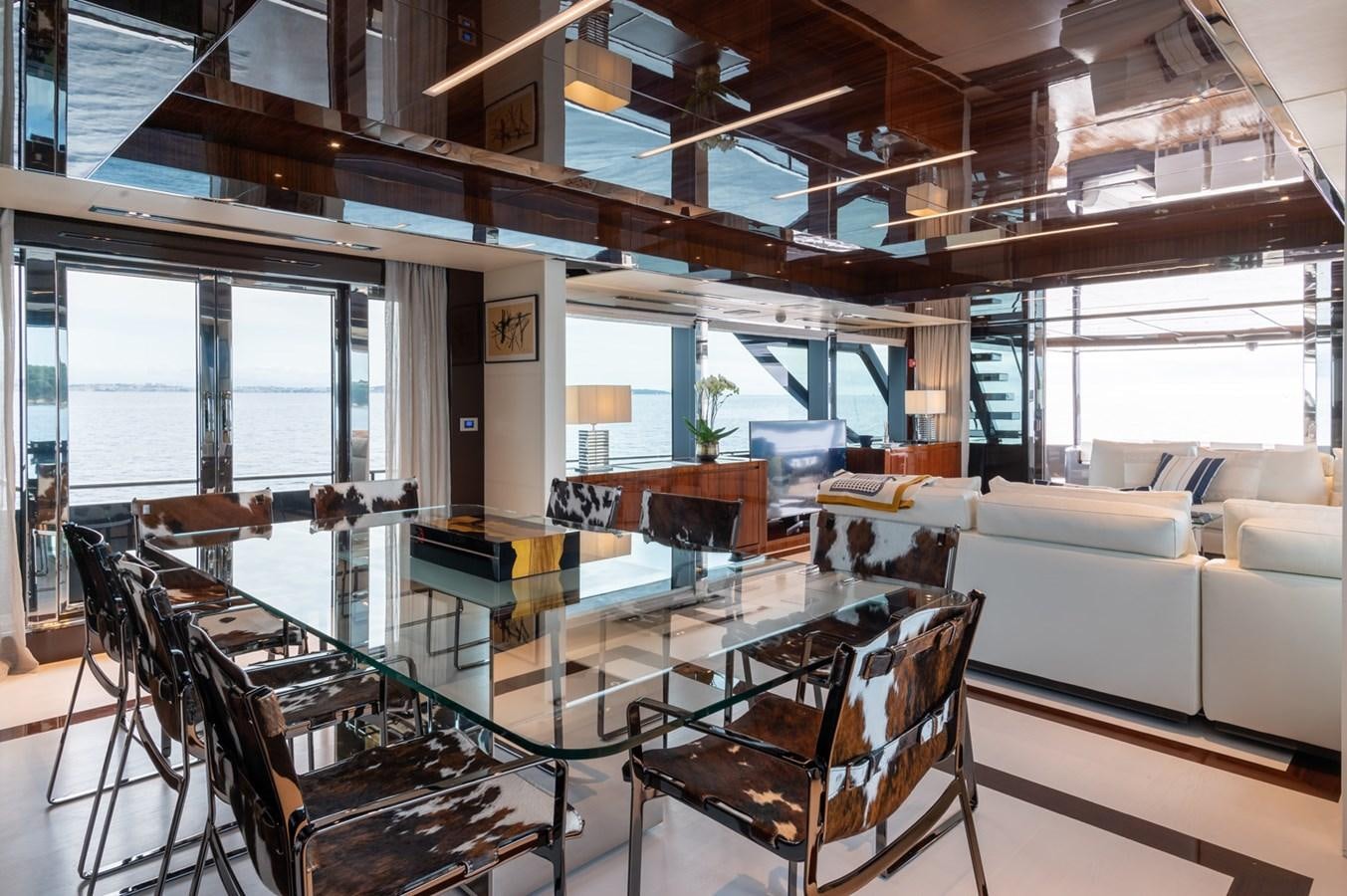 a living room with a table and chairs aboard RIVA DOLCEVITA 110 Yacht for Sale