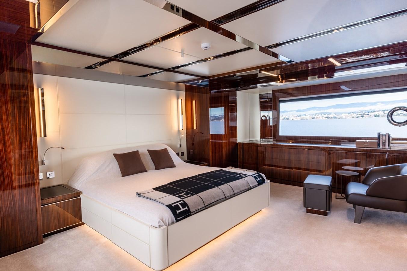 a large room with a bed and a large window aboard RIVA DOLCEVITA 110 Yacht for Sale