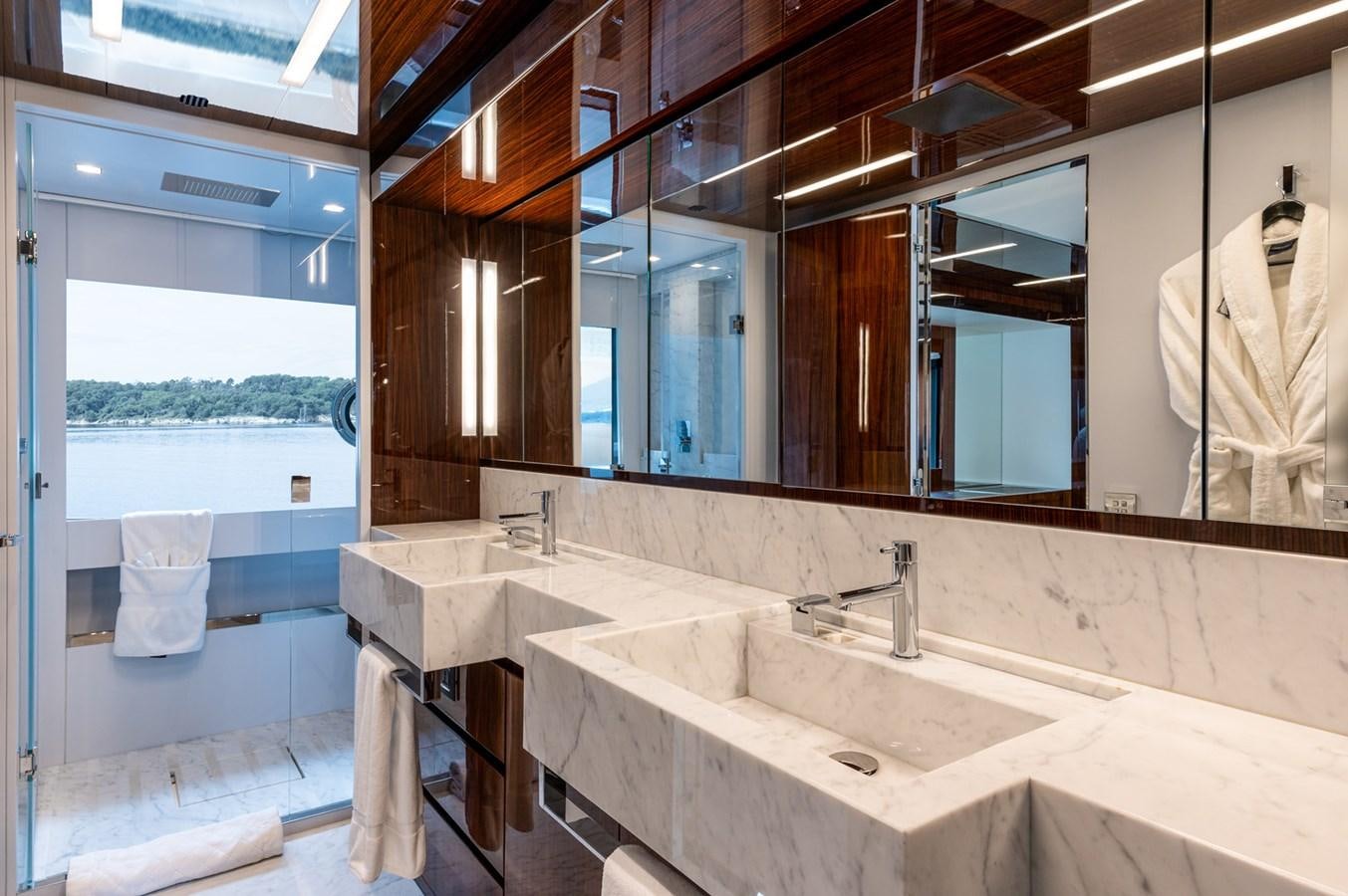 a bathroom with a large mirror aboard RIVA DOLCEVITA 110 Yacht for Sale