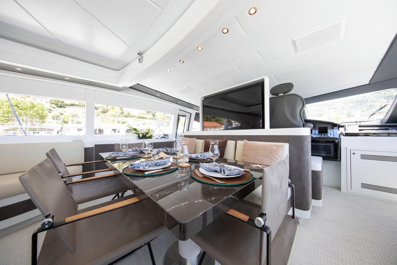a kitchen with a table and chairs aboard BIGCIKI Yacht for Sale