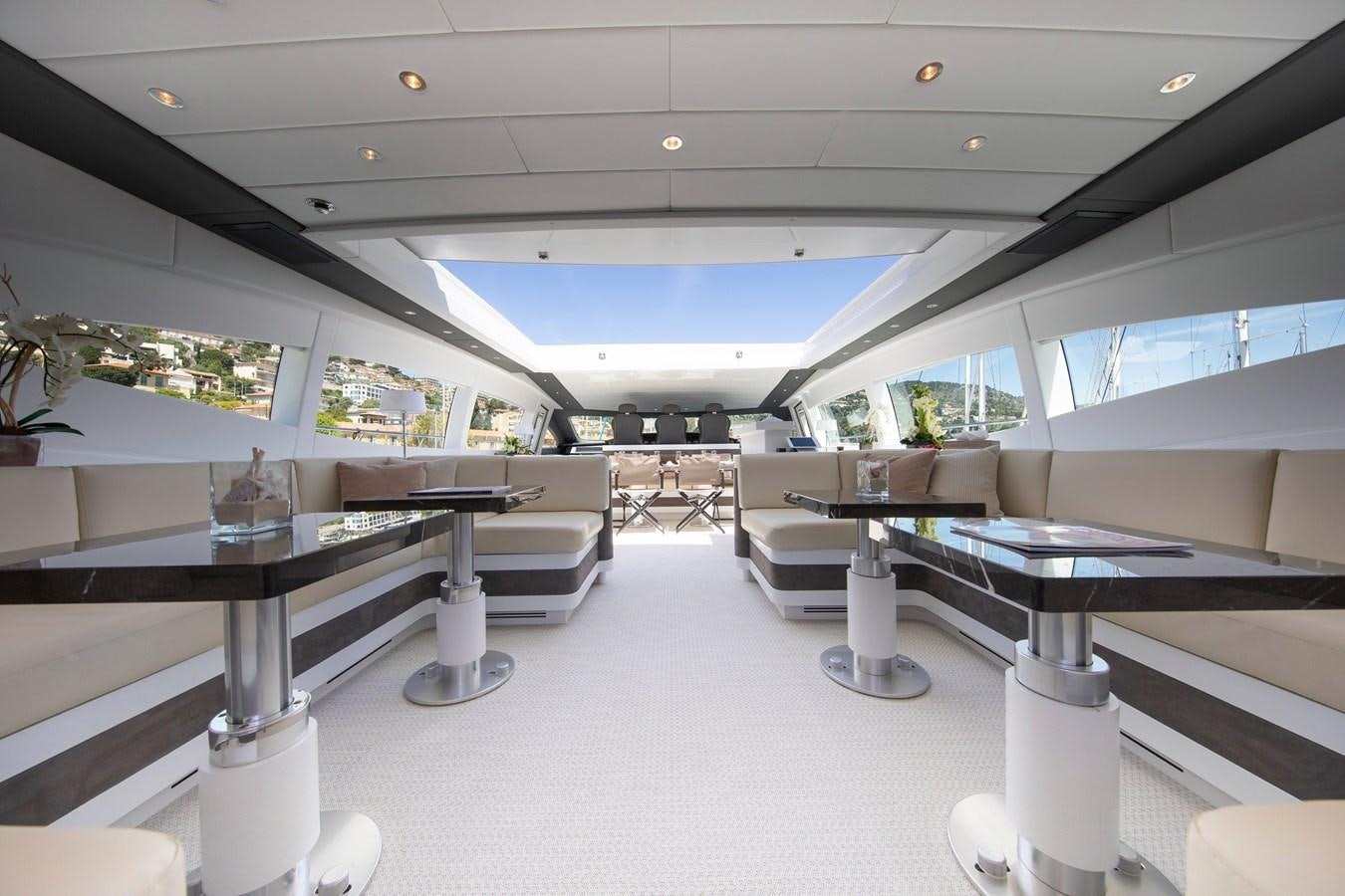 a room with a table and chairs aboard BIGCIKI Yacht for Sale