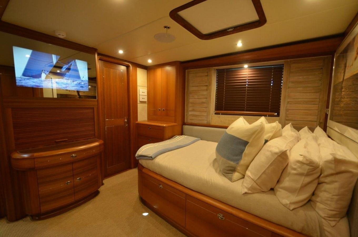 a bedroom with a bed and a television aboard DANNESKJOLD Yacht for Sale