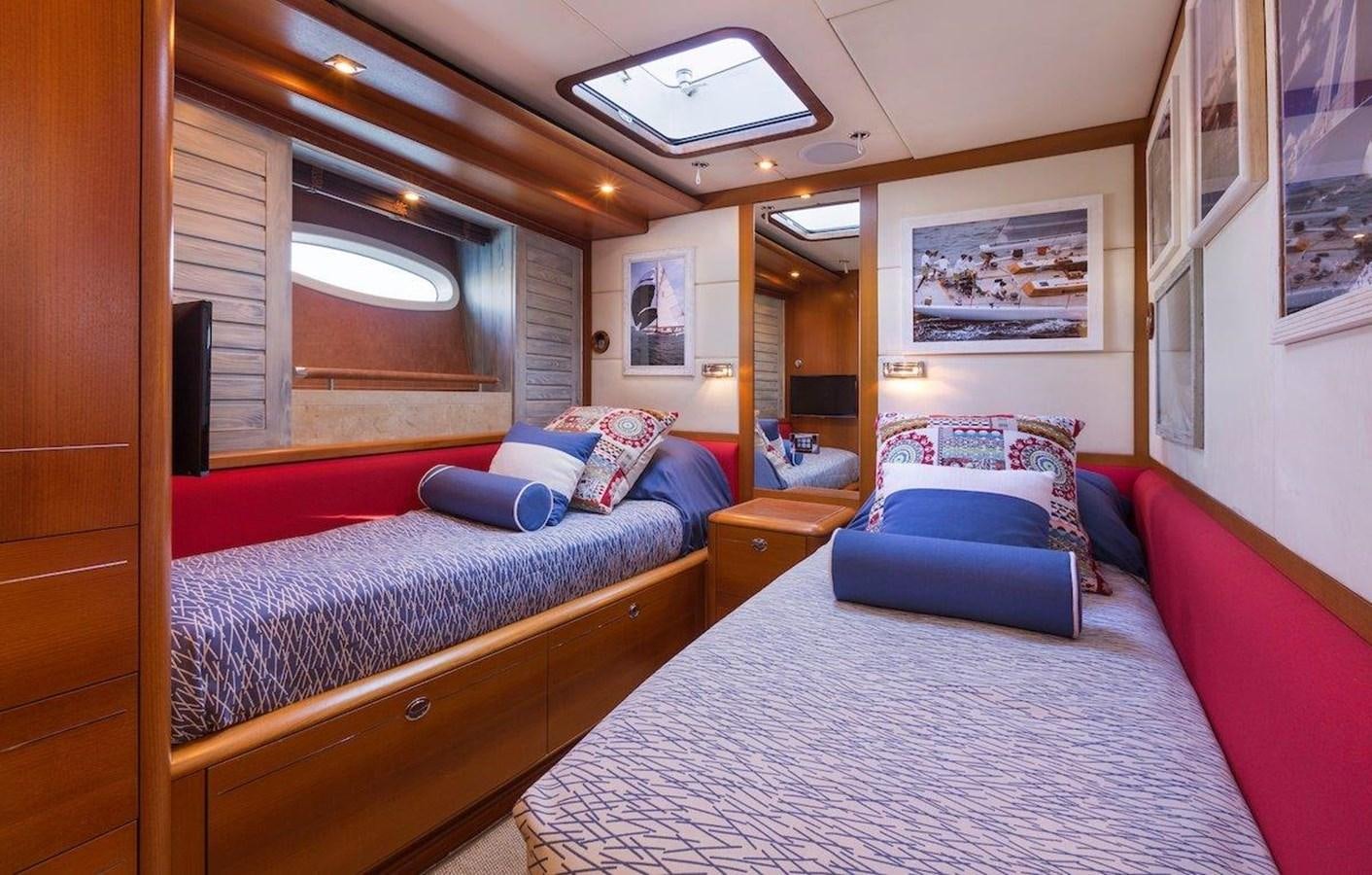 a bedroom with a bed and a window aboard DANNESKJOLD Yacht for Sale