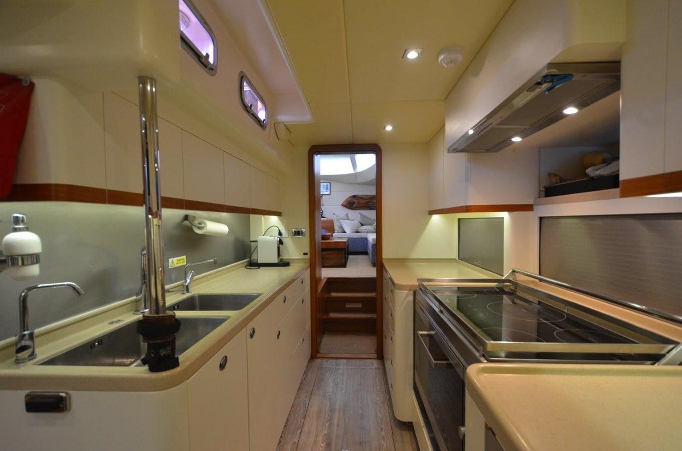 a kitchen with a sink and a large mirror aboard DANNESKJOLD Yacht for Sale