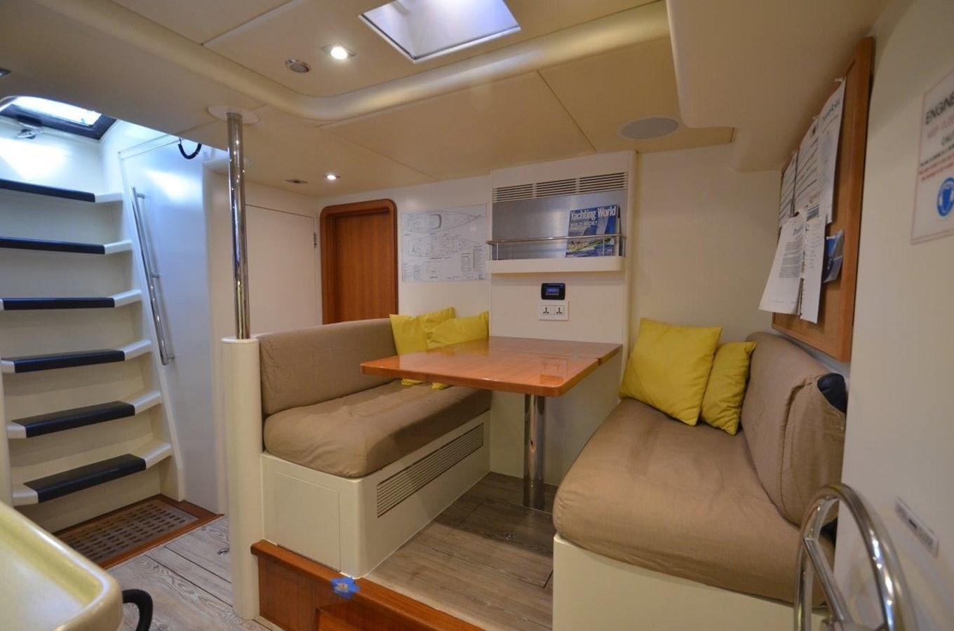 a living room with a desk and a bed aboard DANNESKJOLD Yacht for Sale