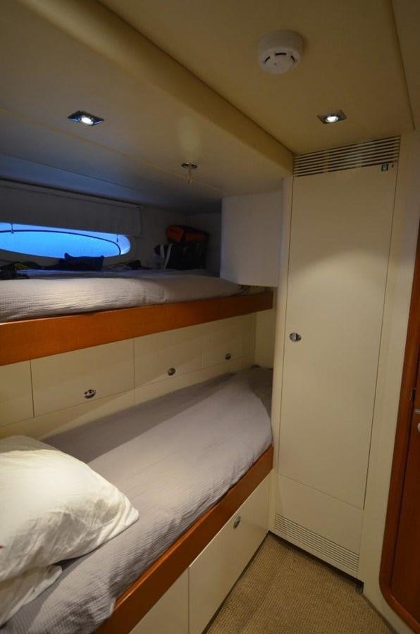 a room with a bed and a television aboard DANNESKJOLD Yacht for Sale