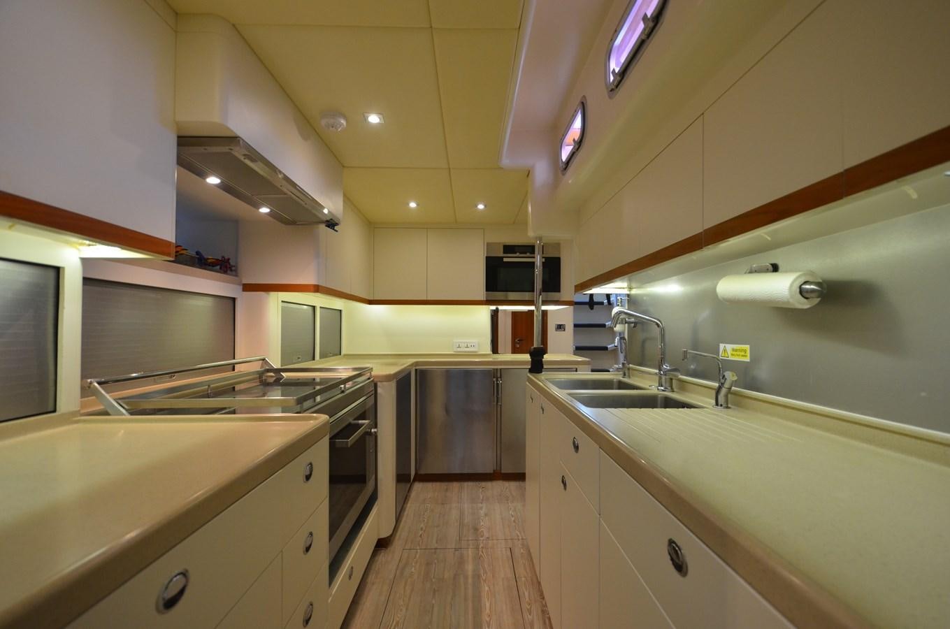a kitchen with white cabinets aboard DANNESKJOLD Yacht for Sale