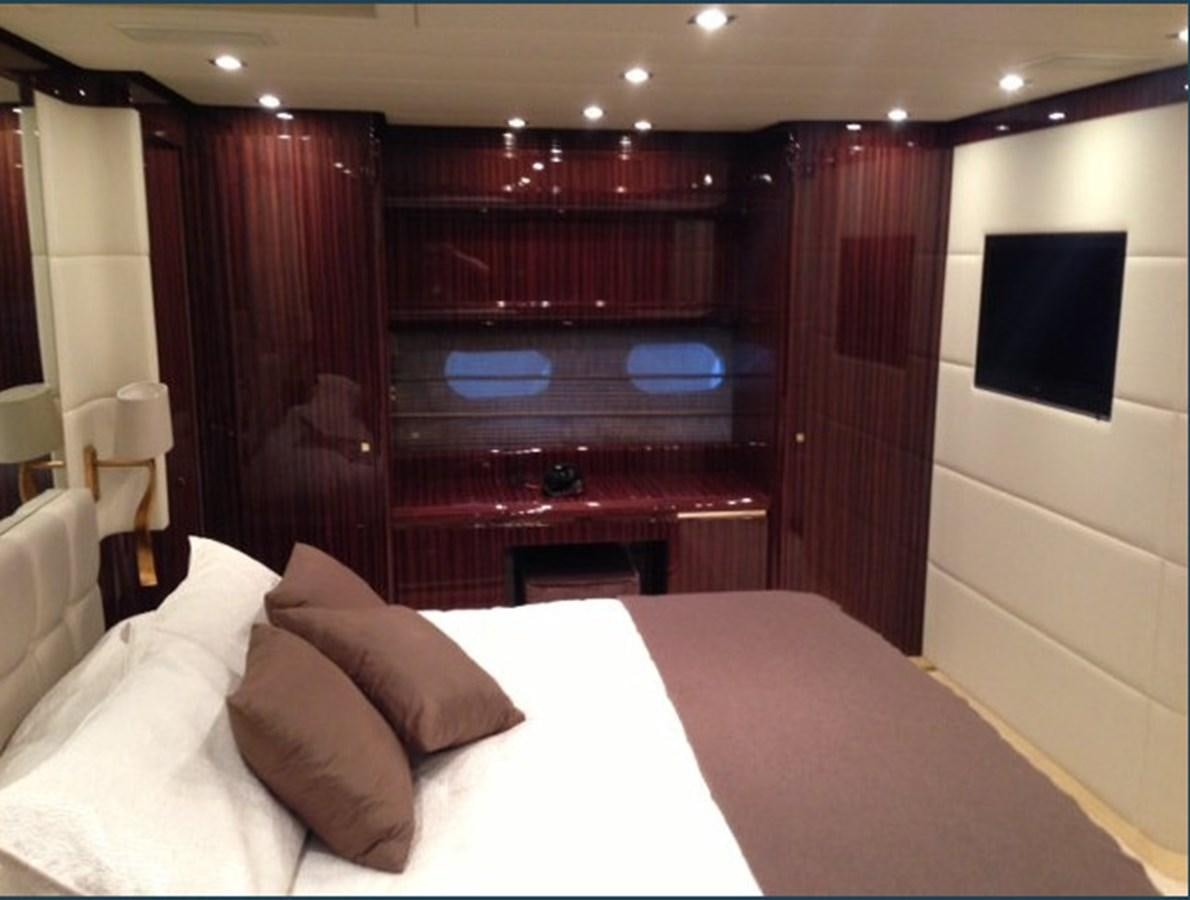 a bed with a white bed spread aboard WHITE PEARL Yacht for Sale