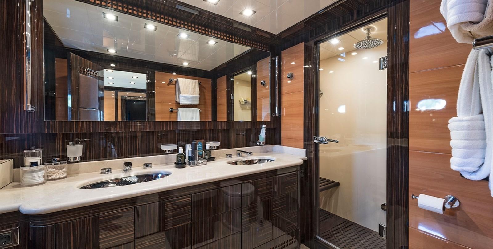 a bathroom with a large mirror aboard GLESS Yacht for Sale