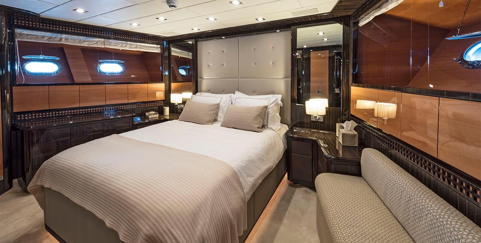 a room with a bed and a couch aboard GLESS Yacht for Sale