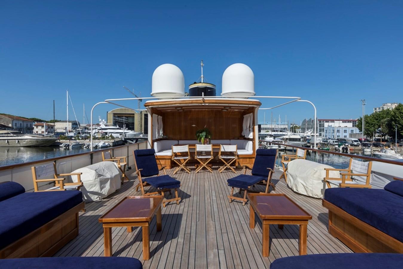 a deck with a deck and chairs and a building with a dome on top aboard LADY MAY OF GLANDORE Yacht for Sale
