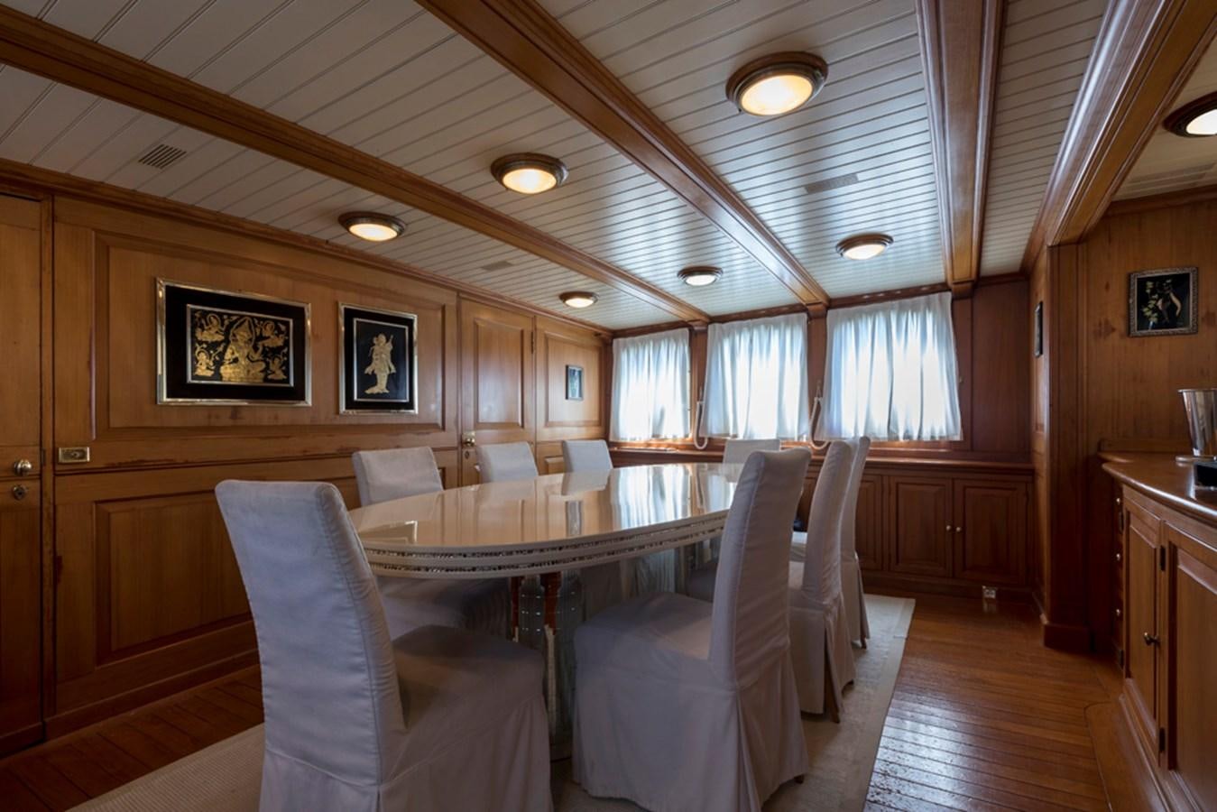 a large dining room with wood paneling aboard LADY MAY OF GLANDORE Yacht for Sale