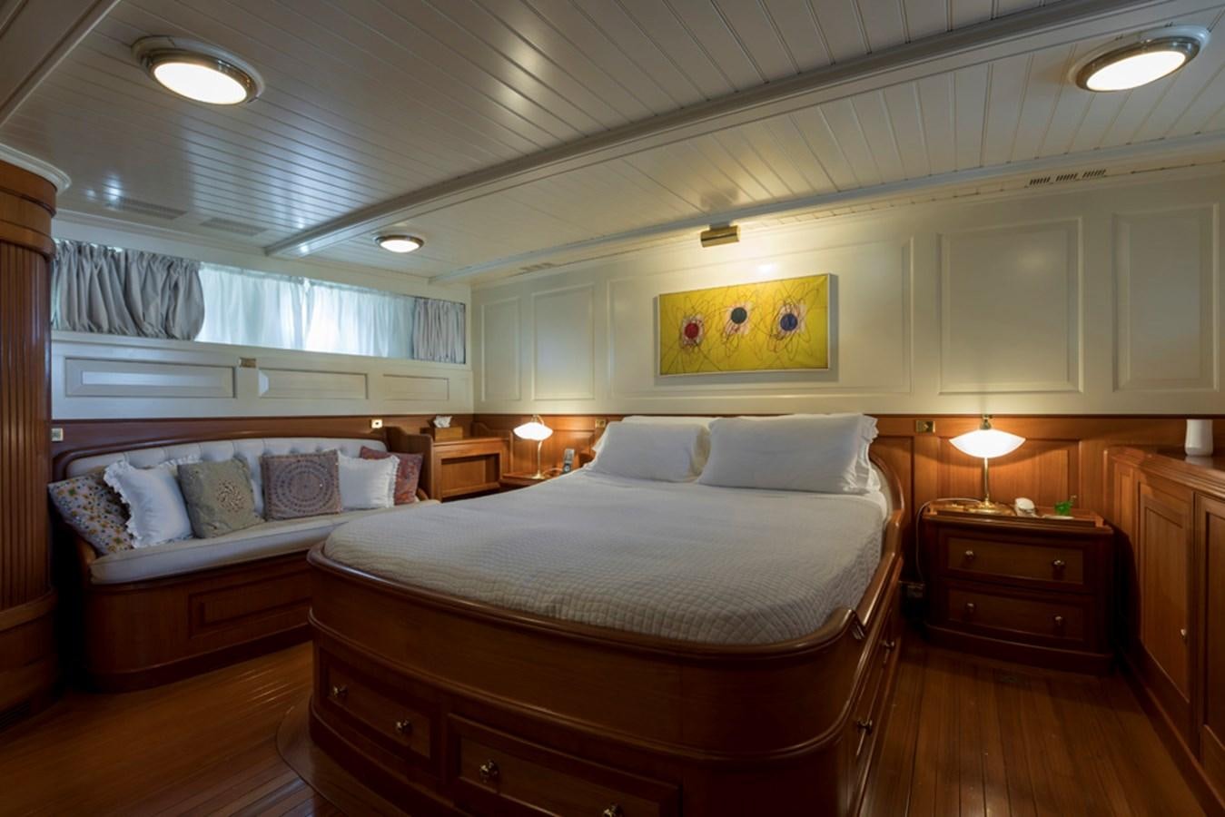 a bedroom with a bed and a dresser aboard LADY MAY OF GLANDORE Yacht for Sale
