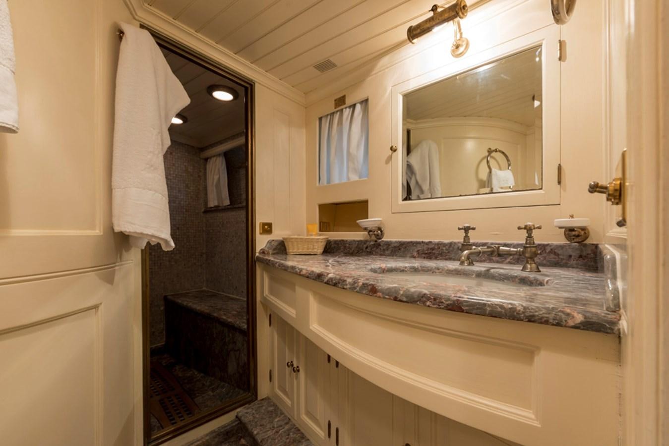 a bathroom with a large mirror aboard LADY MAY OF GLANDORE Yacht for Sale