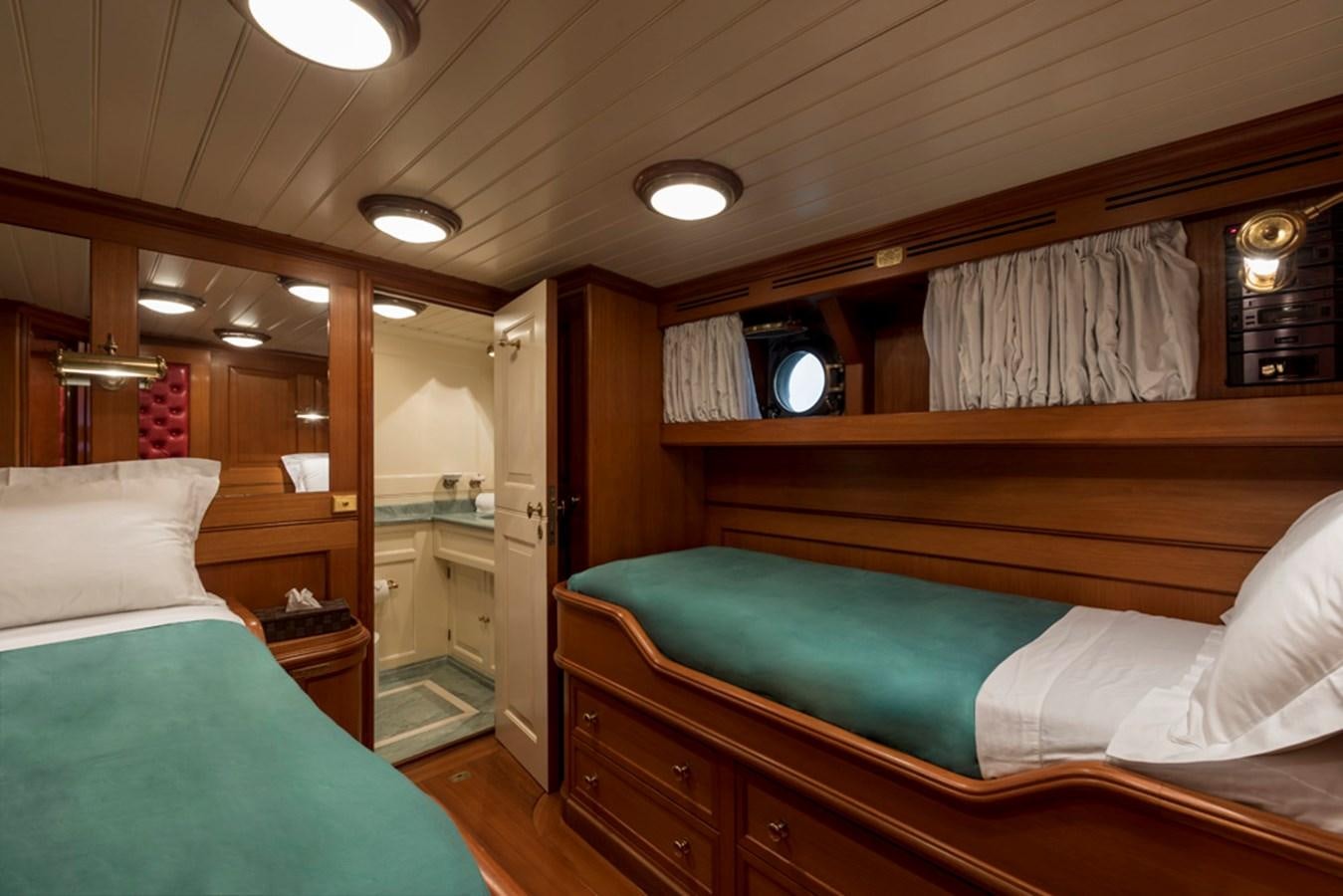 a room with a bed and a mirror aboard LADY MAY OF GLANDORE Yacht for Sale
