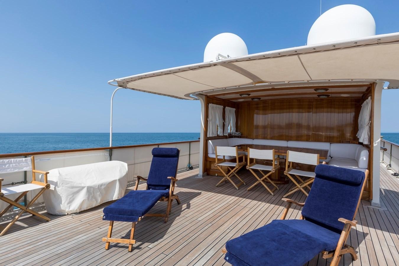 a lounge area with a large white umbrella on top of it aboard LADY MAY OF GLANDORE Yacht for Sale