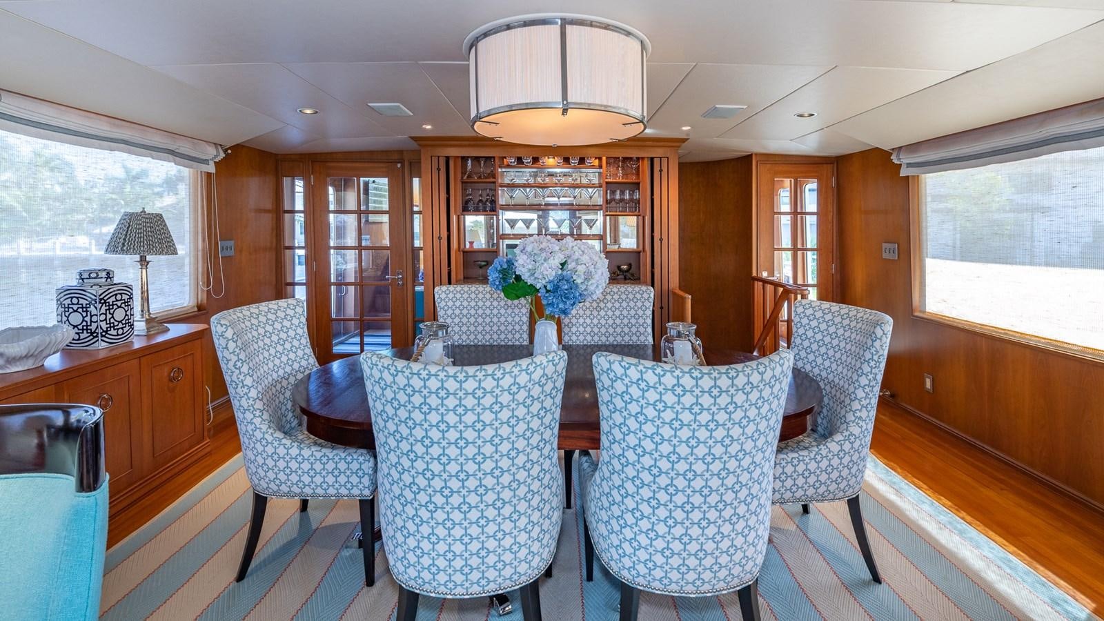 a dining room with a table and chairs aboard SEAQUEL Yacht for Sale