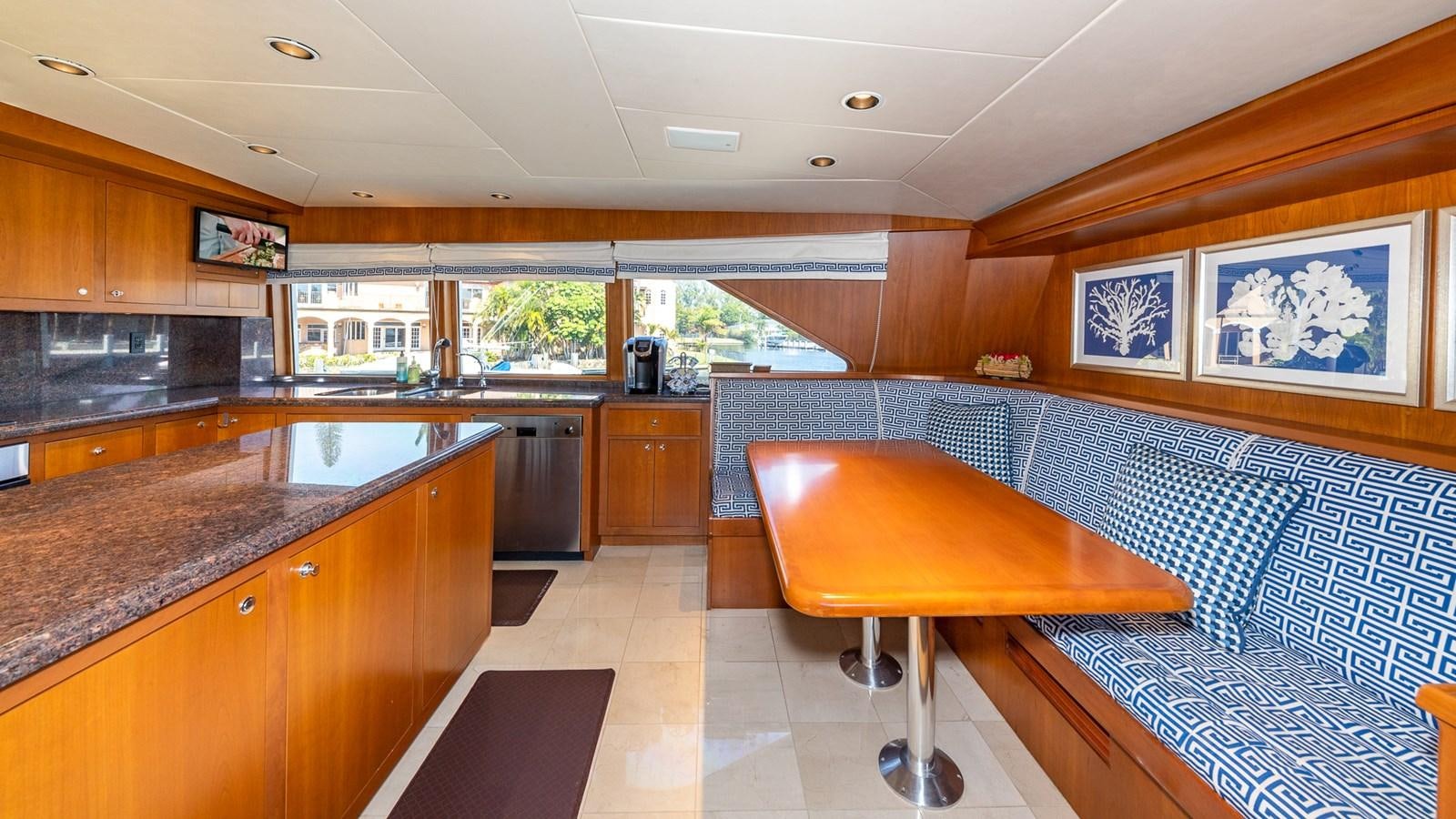 a kitchen with a table and chairs aboard SEAQUEL Yacht for Sale