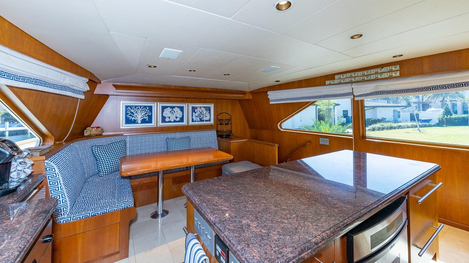 a room with a table and couch aboard SEAQUEL Yacht for Sale