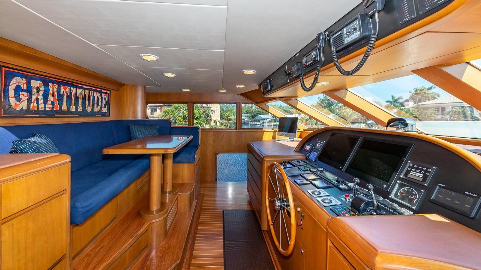 a room with a couch and a table with a computer on it aboard SEAQUEL Yacht for Sale