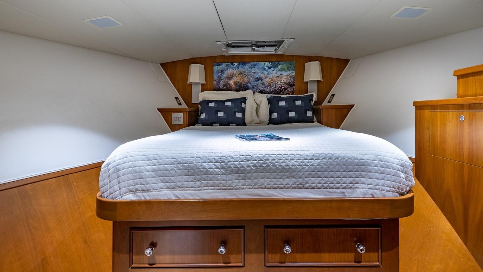 a bedroom with a bed and a desk aboard SEAQUEL Yacht for Sale