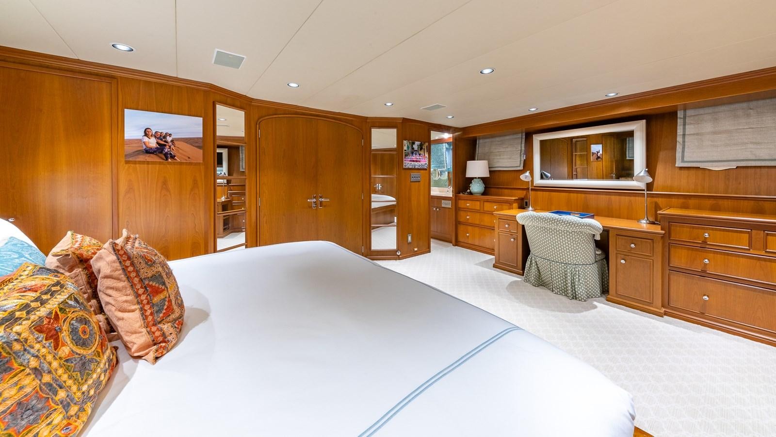 a room with a bed and a chair aboard SEAQUEL Yacht for Sale
