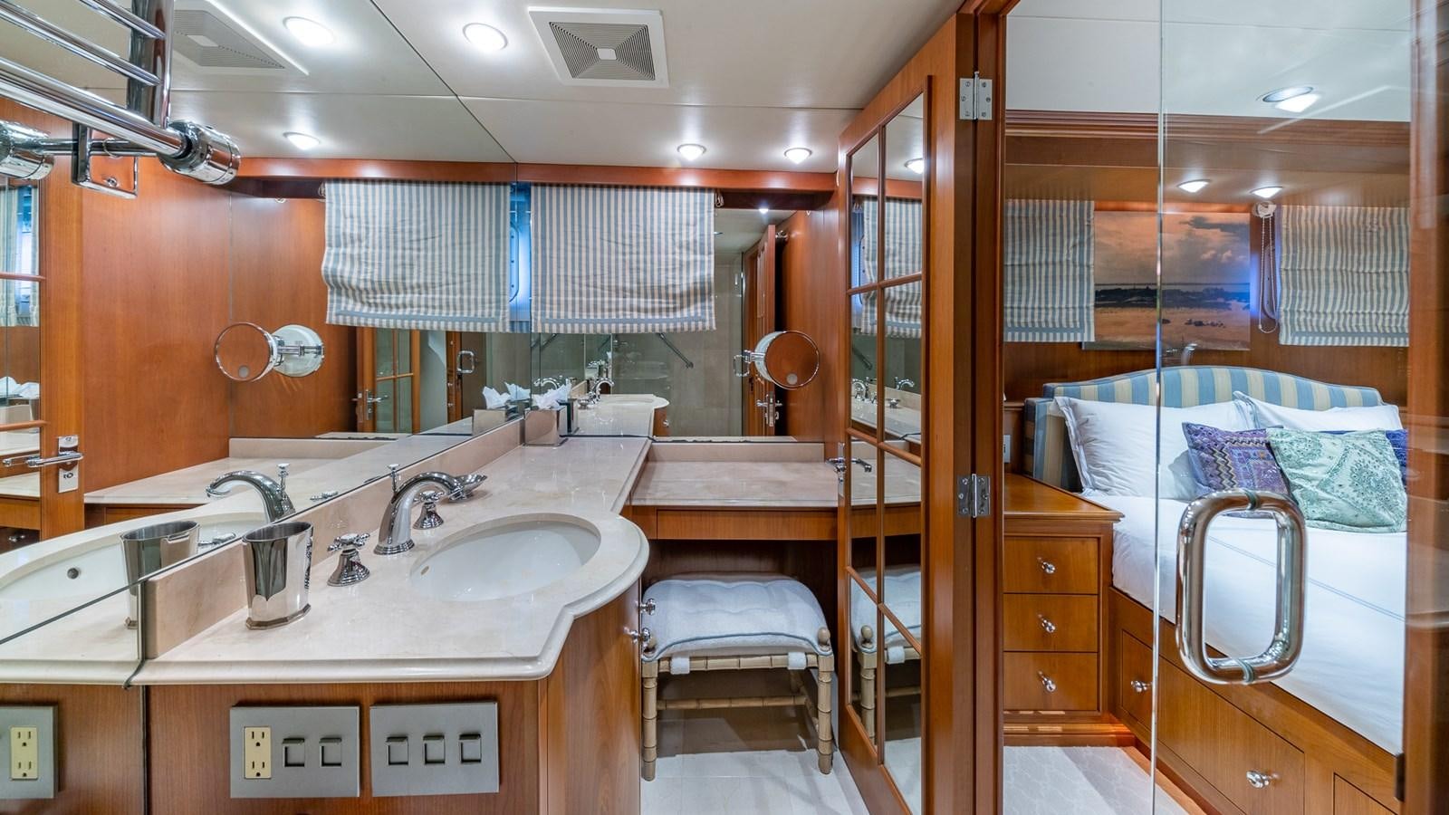 a bathroom with a bed and a sink aboard SEAQUEL Yacht for Sale
