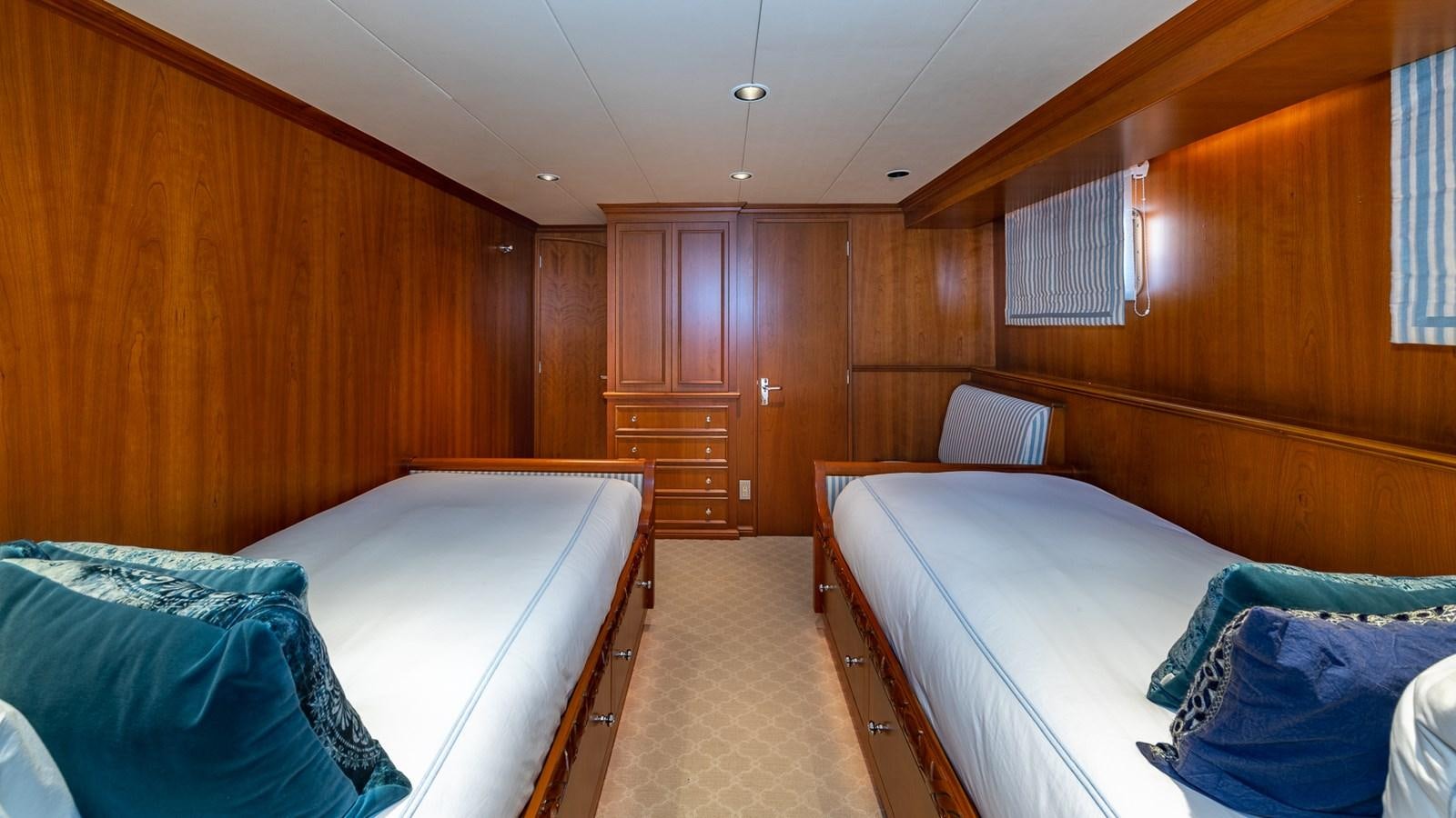 a room with wooden walls and a couple of beds aboard SEAQUEL Yacht for Sale