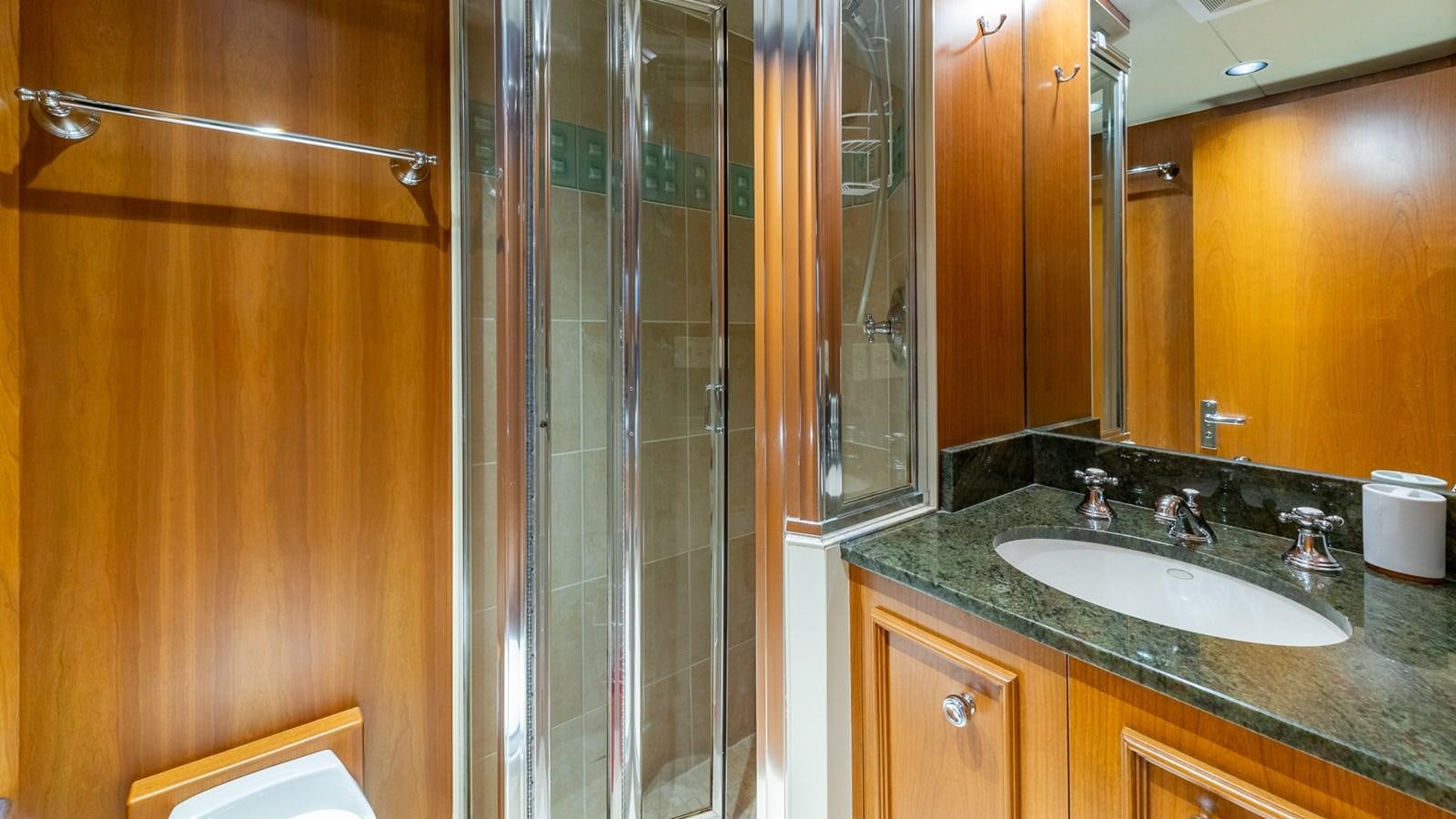 a bathroom with a glass shower aboard SEAQUEL Yacht for Sale
