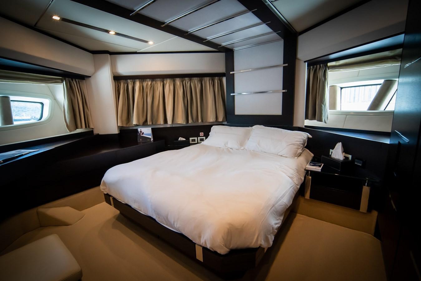 a room with a bed and a window aboard AQUARIUS Yacht for Sale